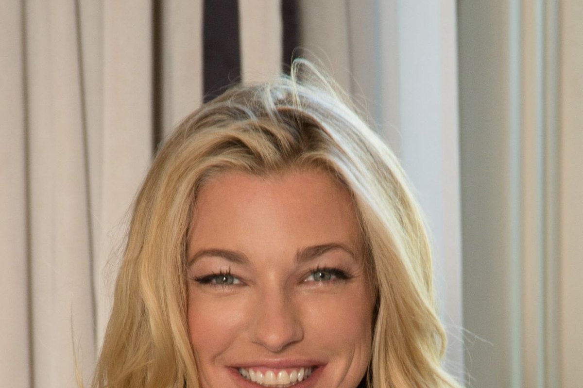 Nicole Junkerman smiling warmly in a close, softly lit portrait